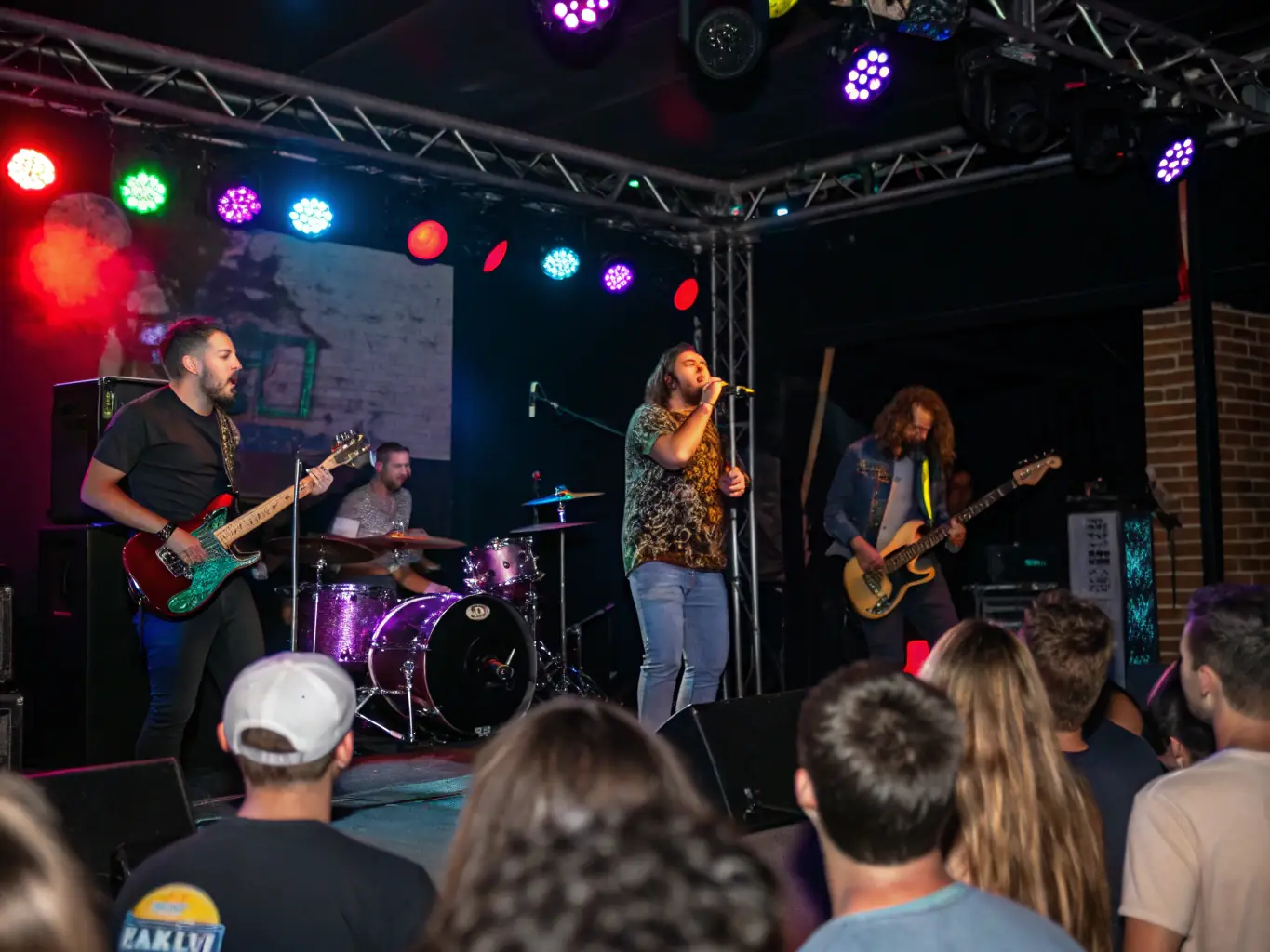 A captivating image of a live musical performance featuring diverse musicians and vocalists, set against a backdrop of enthusiastic audience members.